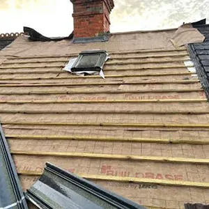 the roof of a house with a broken window