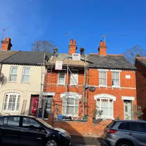 a row of houses with cars parked in front of them