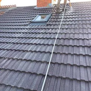 a man on a ladder working on a roof